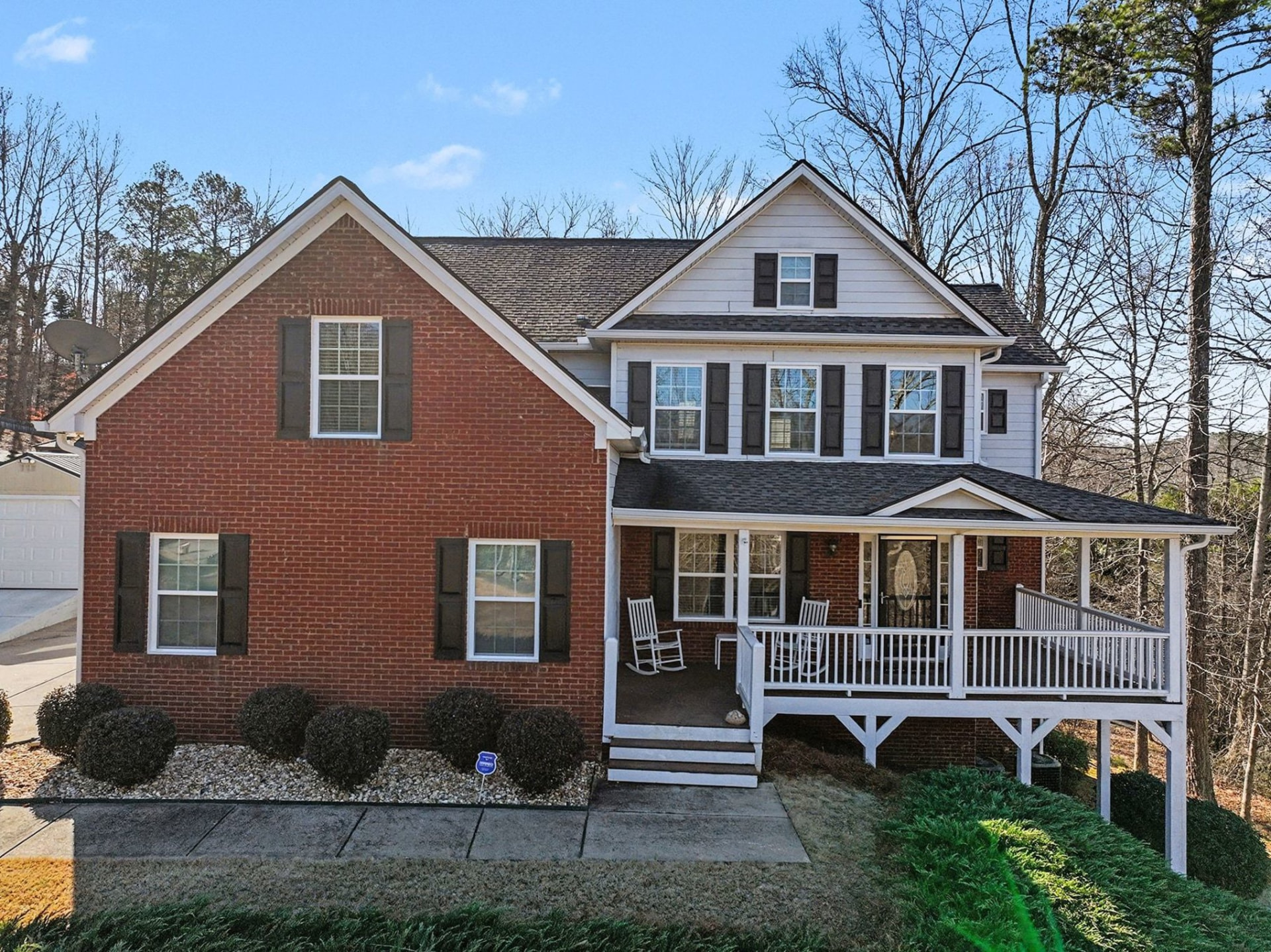 Front elevation of a brick and siding two-story home Peter sold in Cumming, Georgia