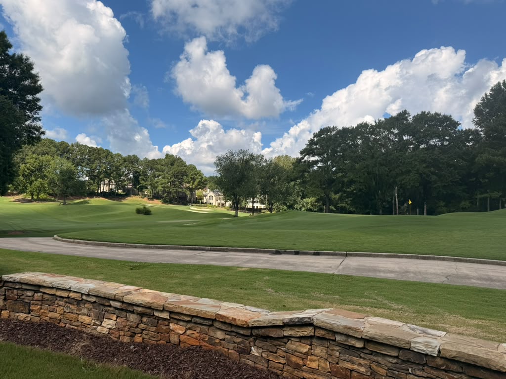 Rolling tree-lined fairway inside St. Marlo Country Club