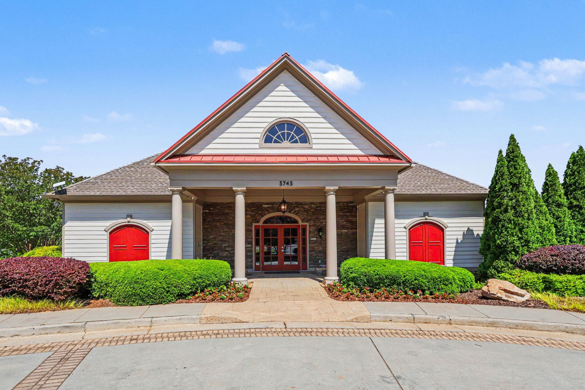 Olde Atlanta Club community clubhouse with red doors and stone entry