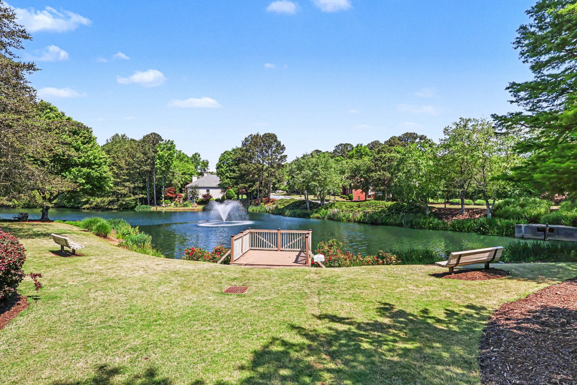 Fountain lake with benches and a viewing deck inside Olde Atlanta Club