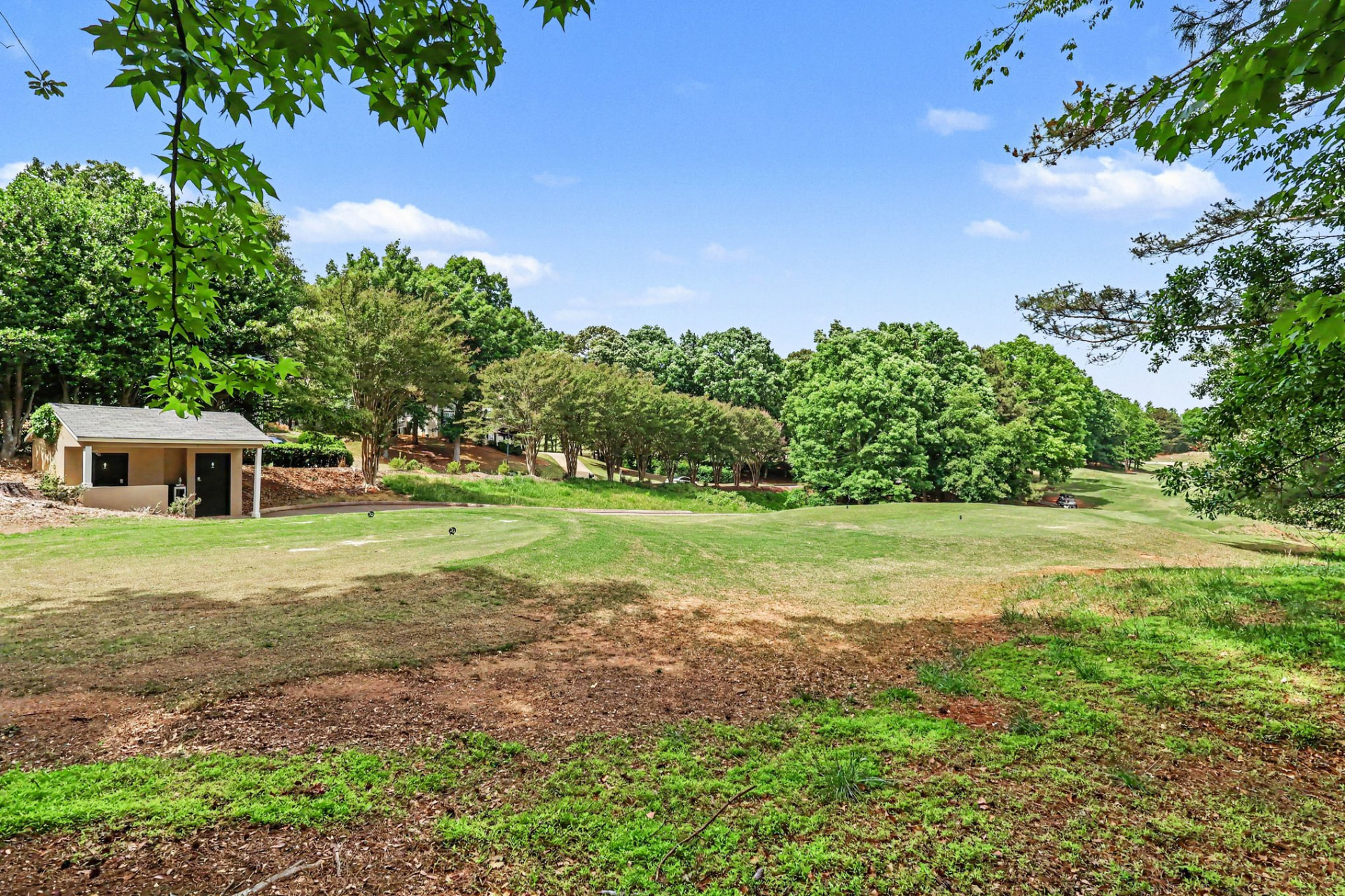 Tree-lined fairway running behind homes at Olde Atlanta Golf Club