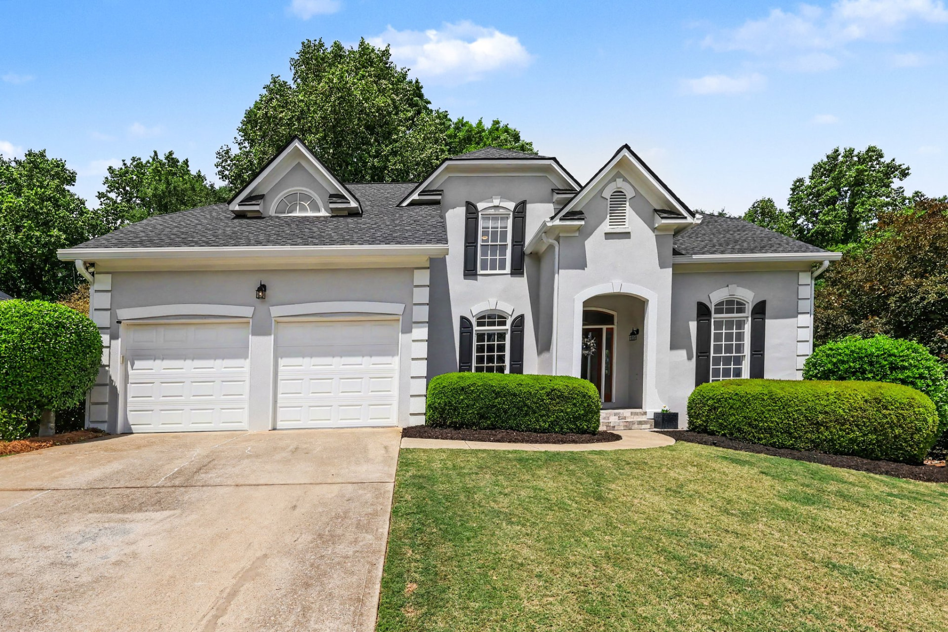 Front elevation of a stucco two-story home Peter sold in Olde Atlanta Club