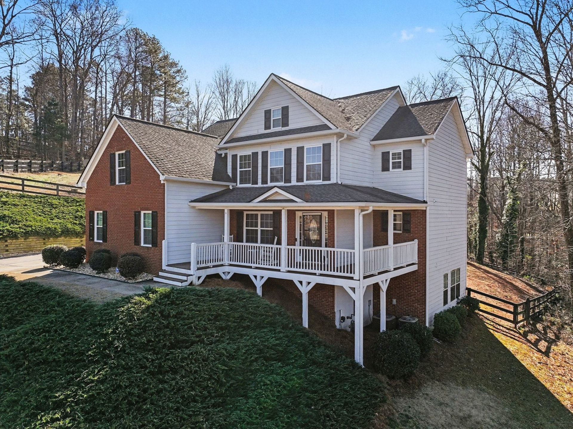 Angled front view of the Cumming home showing its wraparound covered porch