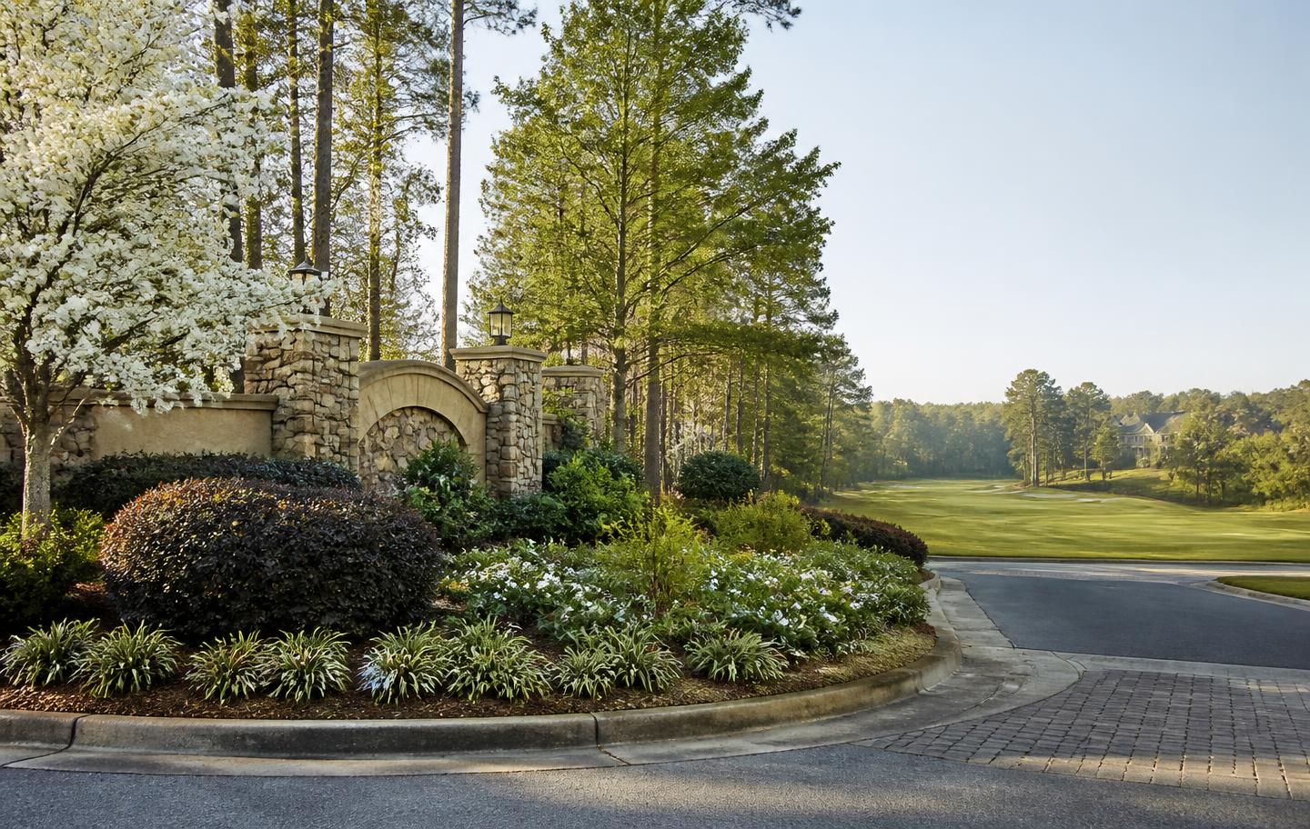 Stone entry monument and golf fairway at the Windermere community